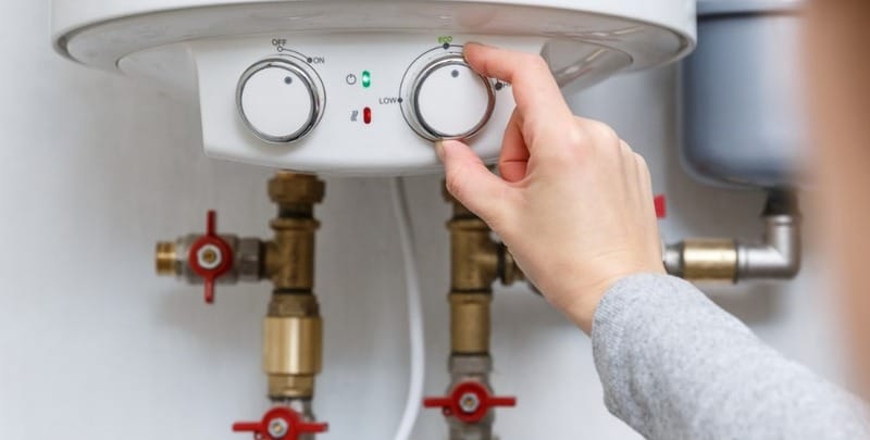 A woman adjust her gas hot water system