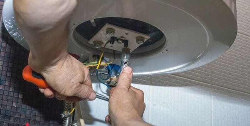 Plumber works on hot water system (Metro Hot Water)